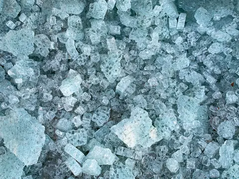 Broken tempered glass in small pieces, close up
